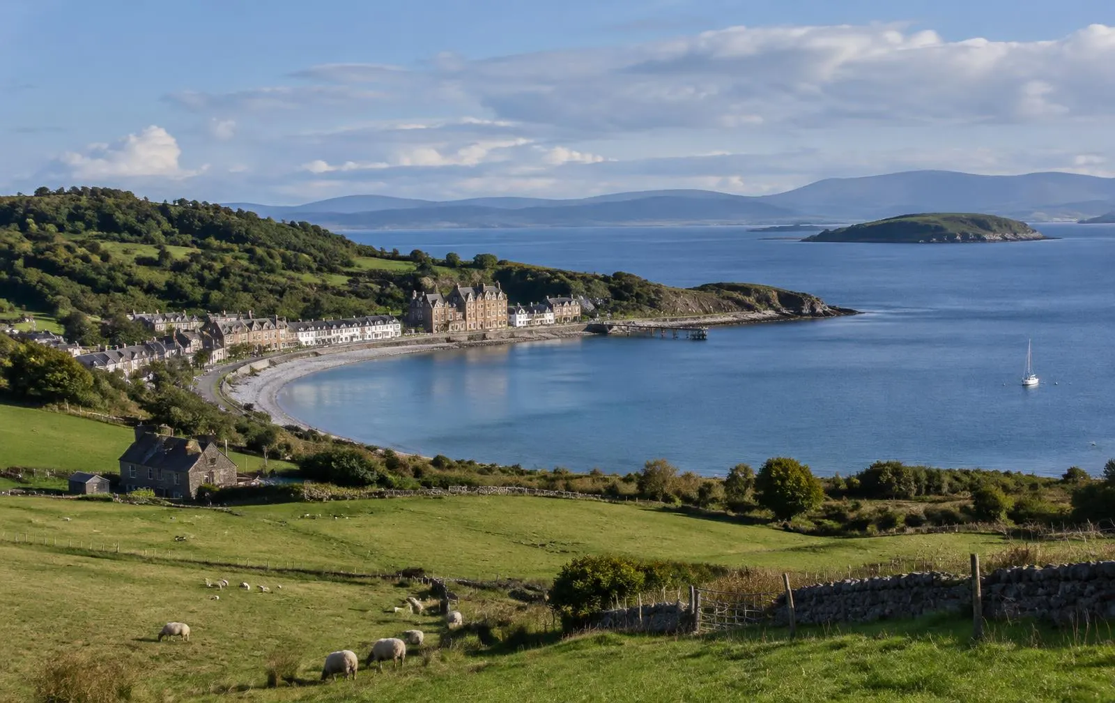 Bay with Victorian houses and green farmland
