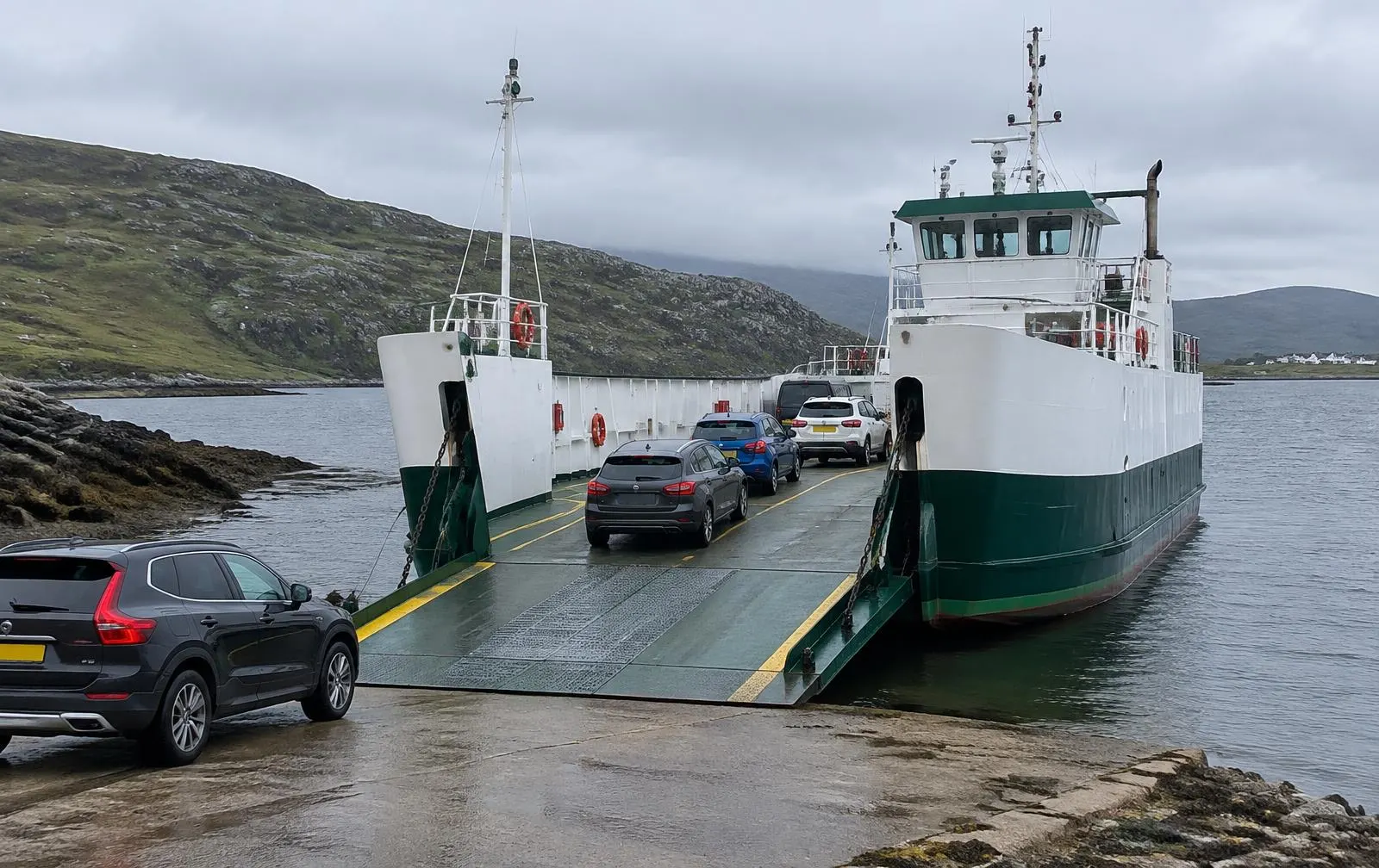 Cars boarding a small ferry at a Highland slipway